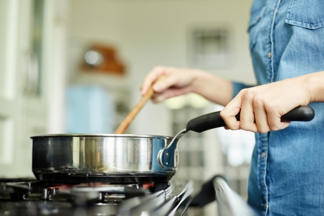 Woman frying potato cakes