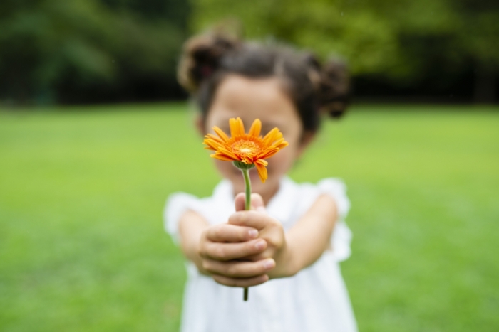 Young girl holding a sunflower