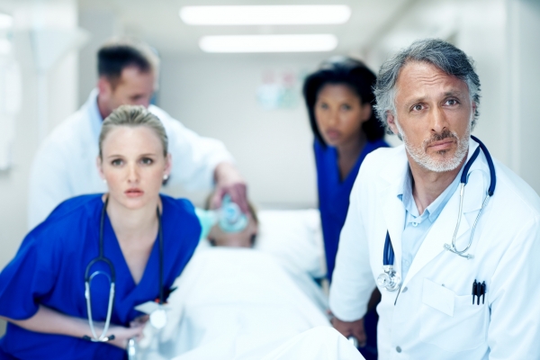 Medical staff rushing a patient on a gurney through the hospital